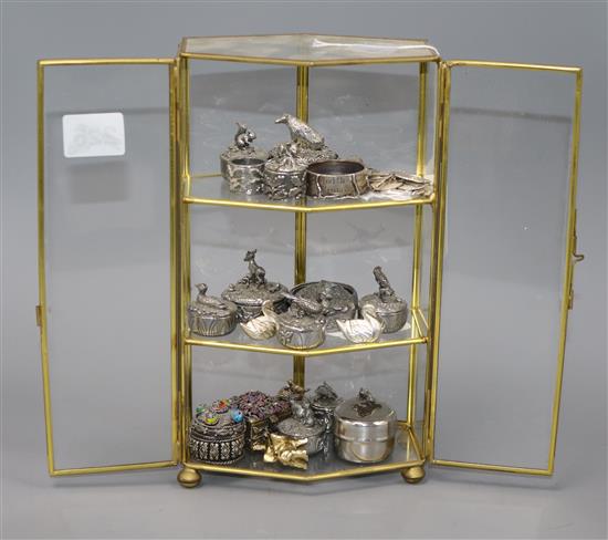 A collection of Woodsetton decorative pewter boxes, miniature animals etc, contained in a small glazed display case